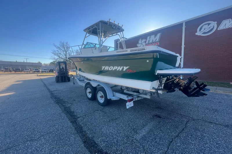 Slide: The Image of 2004 Trophy 2352 Walkaround boat on trailer in parking lot, side view. - 2