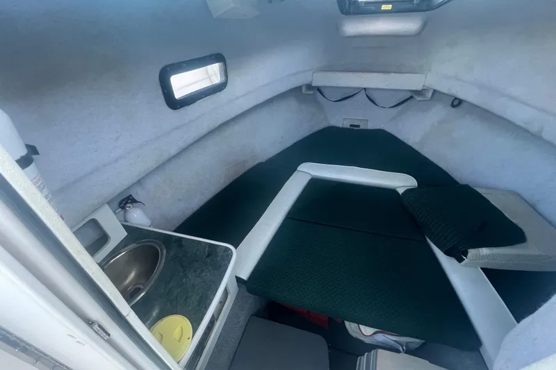 Slide: The Image of 2004 Trophy 2352 Walkaround cabin interior with sink and seating area. - 22