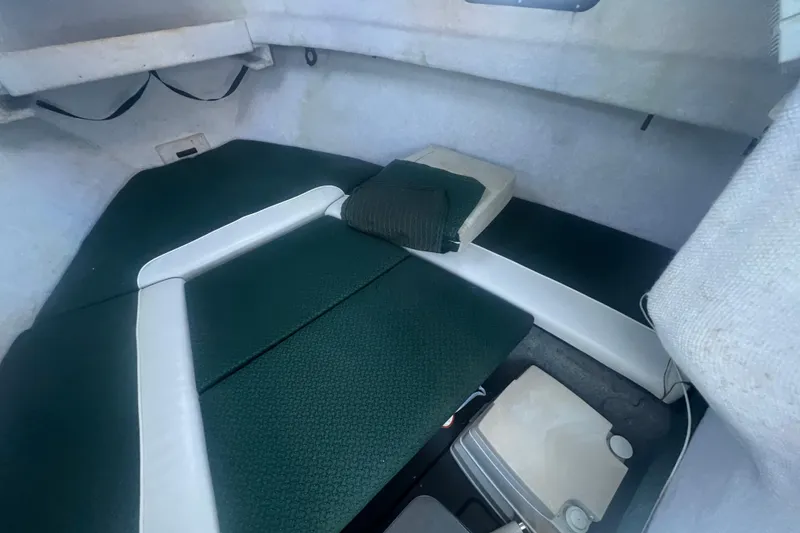 Slide: The Image of 2004 Trophy 2352 Walkaround cabin interior with green and white seating. - 23