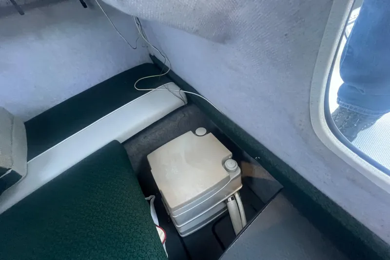 Slide: The Image of Interior of a 2004 Trophy 2352 Walkaround boat showing seating and storage area. - 24