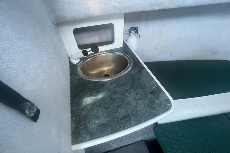 Slide: The Image of 2004 Trophy 2352 Walkaround cabin interior with sink and countertop. - 25
