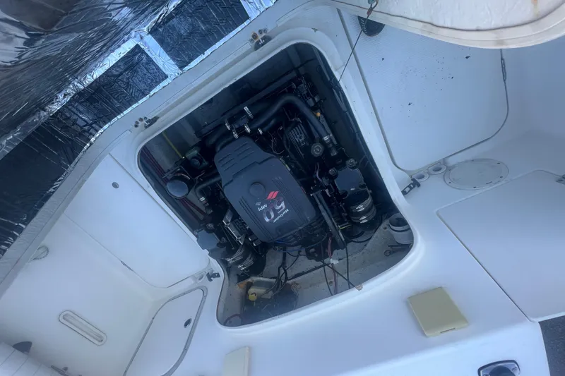 Slide: The Image of Engine compartment of a 2004 Trophy 2352 Walkaround boat, showcasing the engine details. - 29