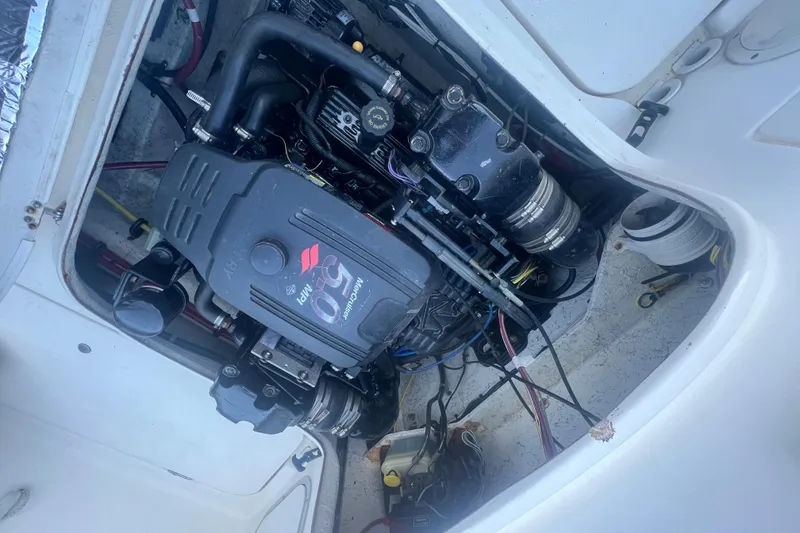 Slide: The Image of Engine compartment of a 2004 Trophy 2352 Walkaround boat, featuring a MerCruiser 5.0 MPI engine. - 30