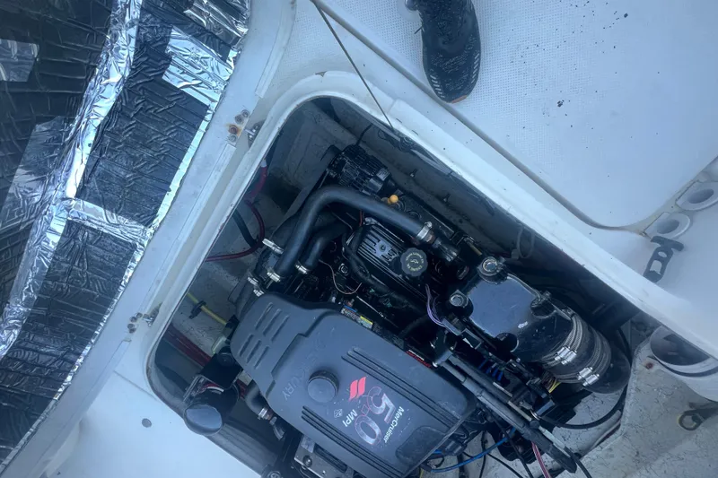 Slide: The Image of Engine compartment of a 2004 Trophy 2352 Walkaround boat, featuring a MerCruiser engine. - 31