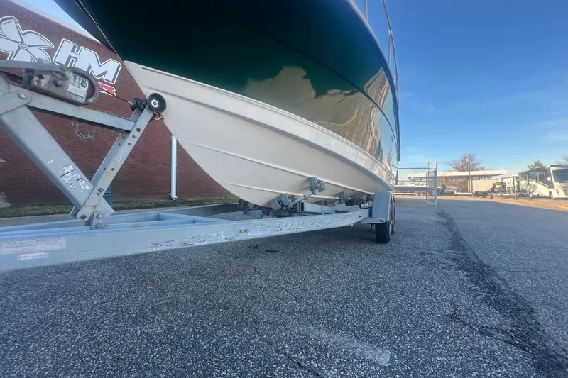 Slide: The Image of 2004 Trophy 2352 Walkaround boat on trailer, parked outdoors on a sunny day. - 34