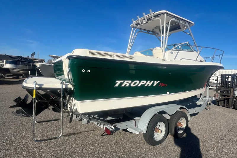 Slide: The Image of 2004 Trophy 2352 Walkaround boat on trailer, green hull, sunny day. - 37
