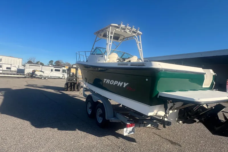 Slide: The Image of 2004 Trophy 2352 Walkaround boat on trailer in sunny outdoor setting. - 39