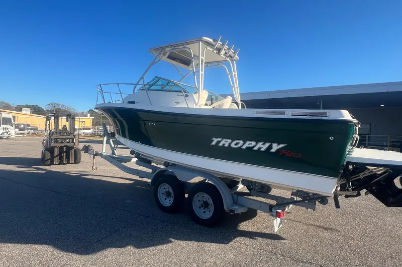 Slide: The Image of 2004 Trophy 2352 Walkaround boat on trailer under clear blue sky. - 40