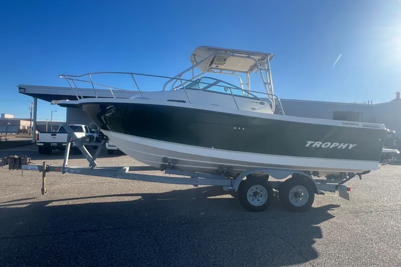Slide: The Image of 2004 Trophy 2352 Walkaround boat on trailer under clear blue sky. - 42