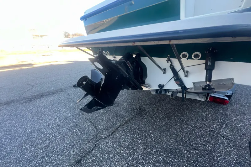 Slide: The Image of 2004 Trophy 2352 Walkaround boat stern with outboard motor and trim tabs. - 6