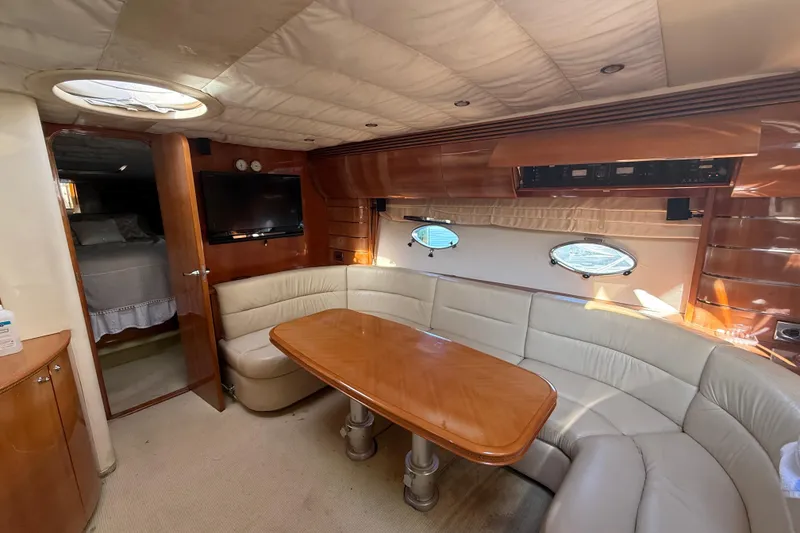 Slide: The Image of Luxurious interior of 2002 Viking Princess V50 yacht with leather seating and wooden table. - 11