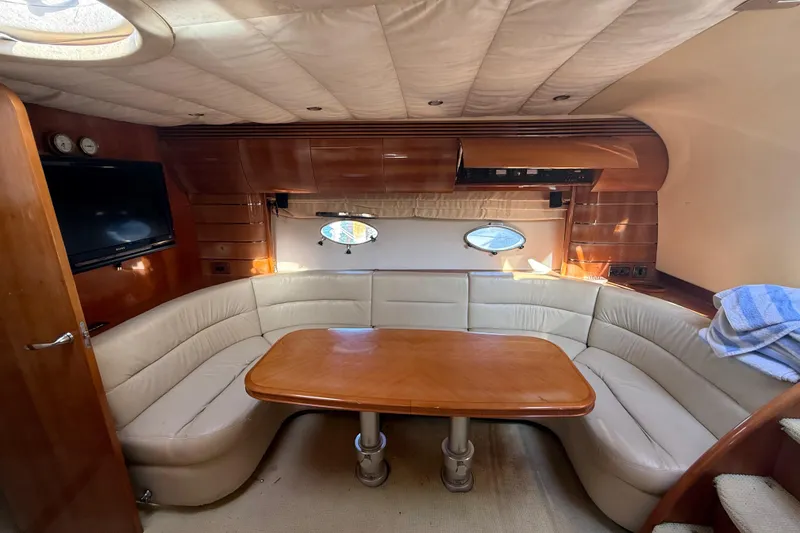 Slide: The Image of Luxurious interior of 2002 Viking Princess V50 yacht with leather seating and wooden table. - 12