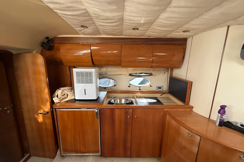 Slide: The Image of Luxurious 2002 Viking Princess V50 yacht interior with wooden cabinetry and modern amenities. - 13