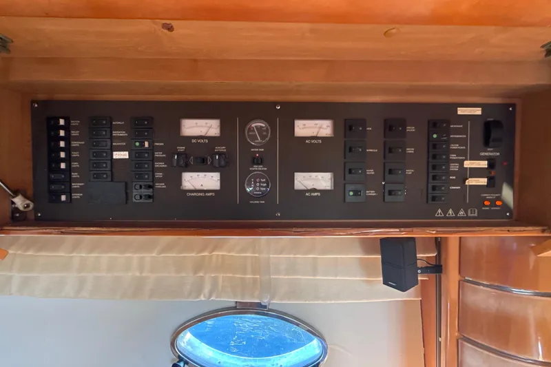 Slide: The Image of Control panel of a 2002 Viking Princess V50 yacht, featuring various switches and gauges. - 20