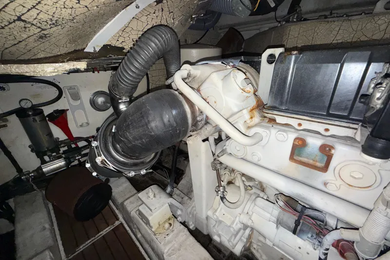 Slide: The Image of Engine room of a 2002 Viking Princess V50 yacht, showing mechanical components and piping. - 21