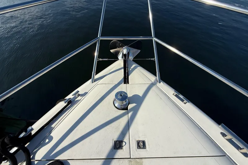 Slide: The Image of Bow of 2002 Viking Princess V50 yacht with anchor and railing on calm water. - 26