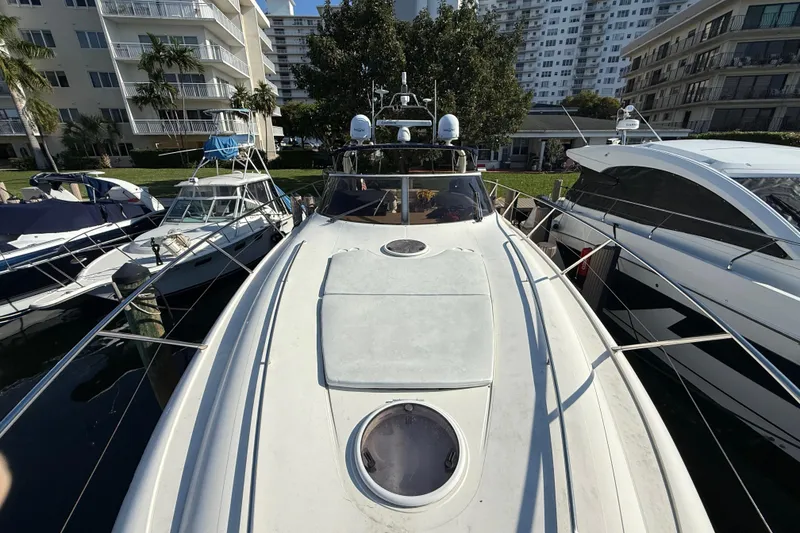 Slide: The Image of 2002 Viking Princess V50 yacht docked among other boats in a marina. - 28