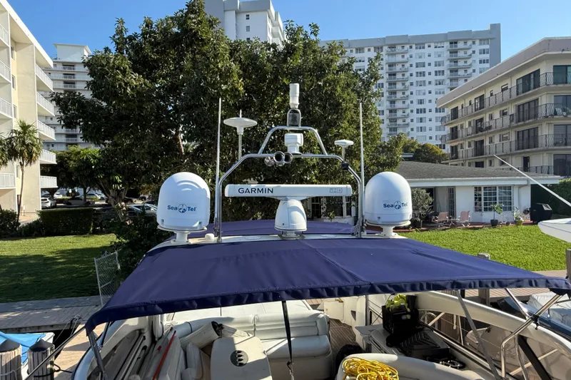 Slide: The Image of 2002 Viking Princess V50 yacht with Garmin and Sea Tel equipment, docked near buildings. - 29