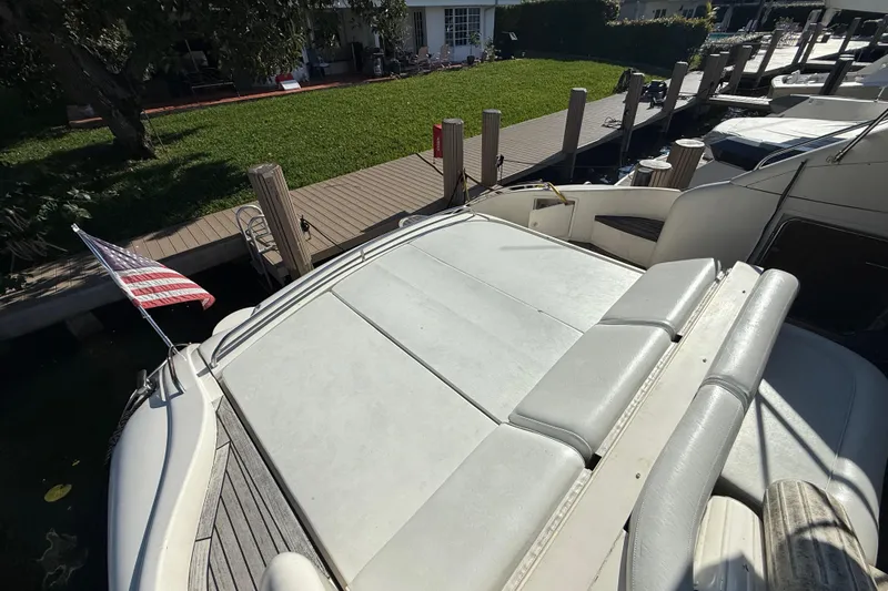 Slide: The Image of 2002 Viking Princess V50 yacht docked with American flag, spacious sun deck. - 30