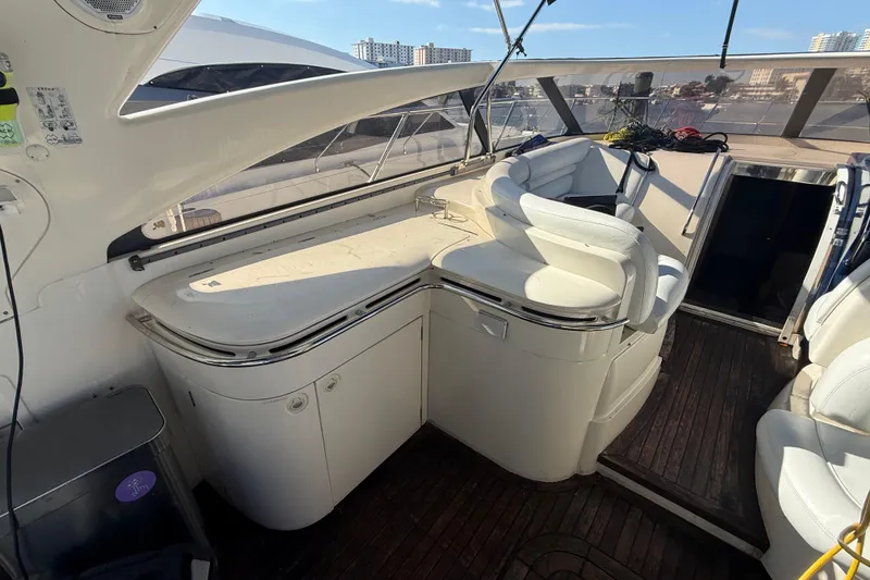 Slide: The Image of Interior of 2002 Viking Princess V50 yacht with white seating and wooden flooring. - 5