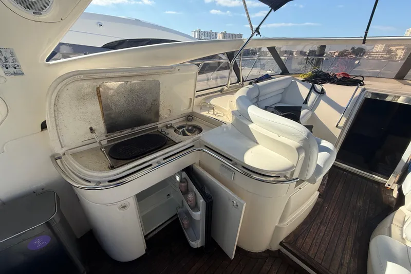 Slide: The Image of 2002 Viking Princess V50 yacht interior with kitchenette and seating area. - 6