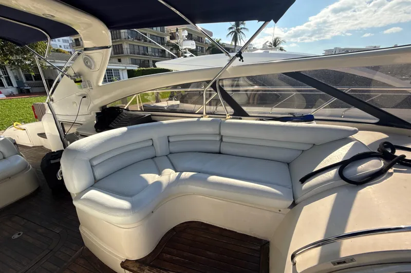 Slide: The Image of Luxurious seating area on a 2002 Viking Princess V50 yacht, featuring white leather upholstery. - 7