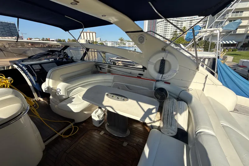 Slide: The Image of Luxurious 2002 Viking Princess V50 yacht interior with seating and table, docked at marina. - 8