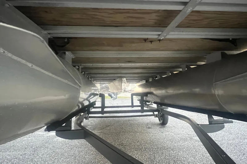 Slide: The Image of Underneath view of 2024 Bentley Pontoons 200 Navigator, showcasing pontoons and trailer. - 13