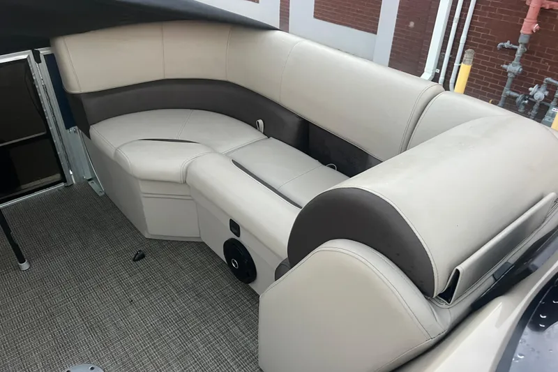Slide: The Image of 2024 Bentley Pontoons 200 Navigator interior with beige and brown seating. - 15