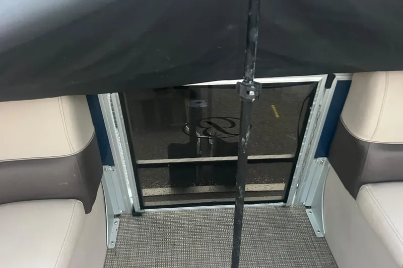 Slide: The Image of 2024 Bentley Pontoons 200 Navigator interior with seating and flooring details. - 16