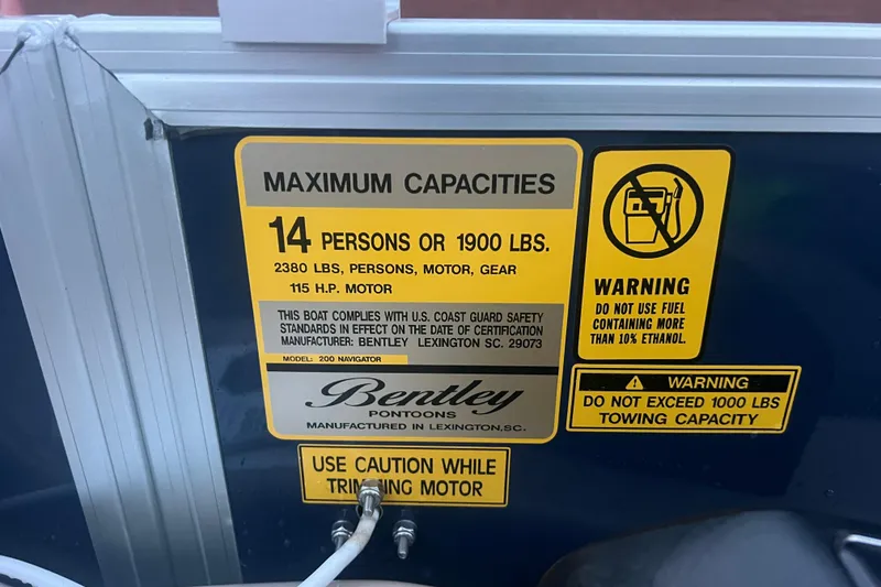 Slide: The Image of 2024 Bentley Pontoons 200 Navigator capacity label, 14 persons, 1900 lbs, safety warnings. - 22