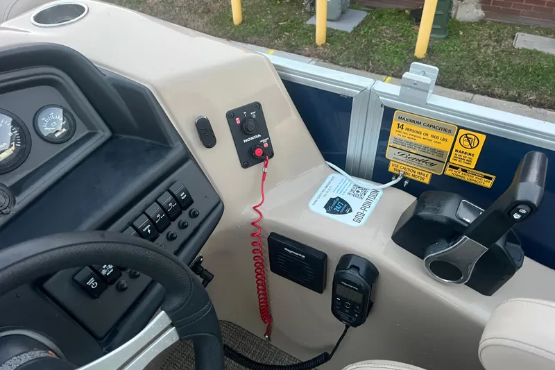 Slide: The Image of 2024 Bentley Pontoons 200 Navigator dashboard with controls and capacity warning labels. - 23