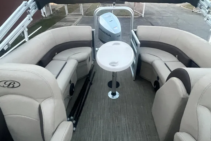 Slide: The Image of 2024 Bentley Pontoons 200 Navigator interior with seating and table, featuring a Honda motor. - 27