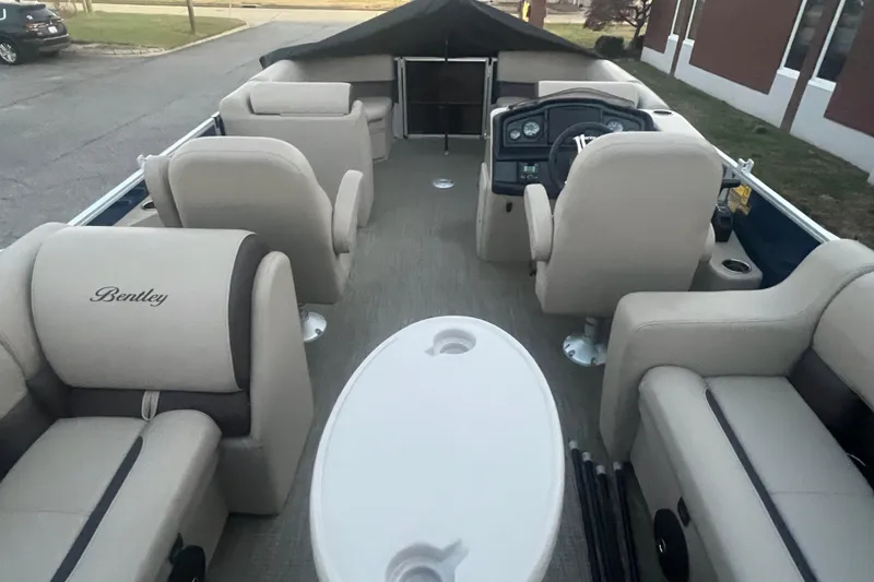 Slide: The Image of 2024 Bentley Pontoons 200 Navigator interior with beige seating and steering console. - 36