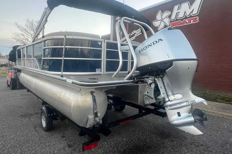 Slide: The Image of 2024 Bentley Pontoons 200 Navigator with Honda outboard motor, parked outside HM Boats. - 4