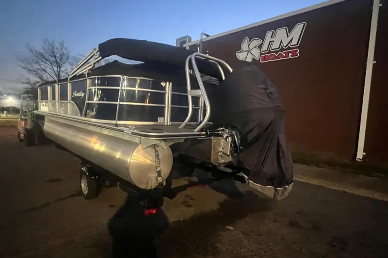Slide: The Image of 2024 Bentley Pontoons 200 Navigator on trailer at dusk near HM Boats building. - 40
