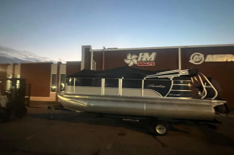 Slide: The Image of 2024 Bentley Pontoons 200 Navigator at dusk outside HM Boats building. - 42