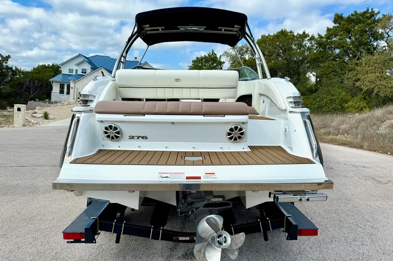Slide: The Image of 2011 Cobalt 276 boat rear view with teak deck and dual propellers. - 11