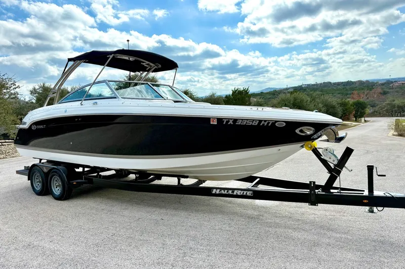 Slide: The Image of 2011 Cobalt 276 boat on trailer under cloudy sky. - 13