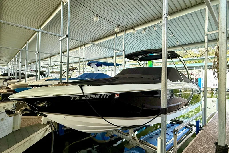 Slide: The Image of 2011 Cobalt 276 boat docked in covered marina, side view. - 15