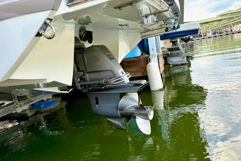 Slide: The Image of 2011 Cobalt 276 boat stern with propeller in marina water. - 20
