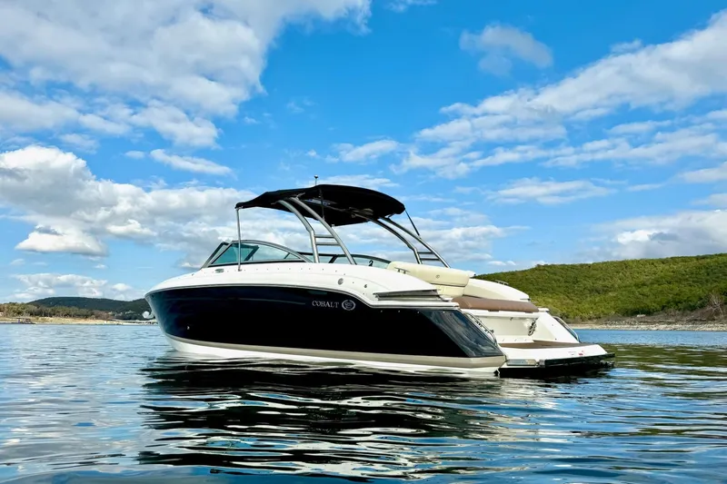 Slide: The Image of 2011 Cobalt 276 boat on calm water under a blue sky. - 3