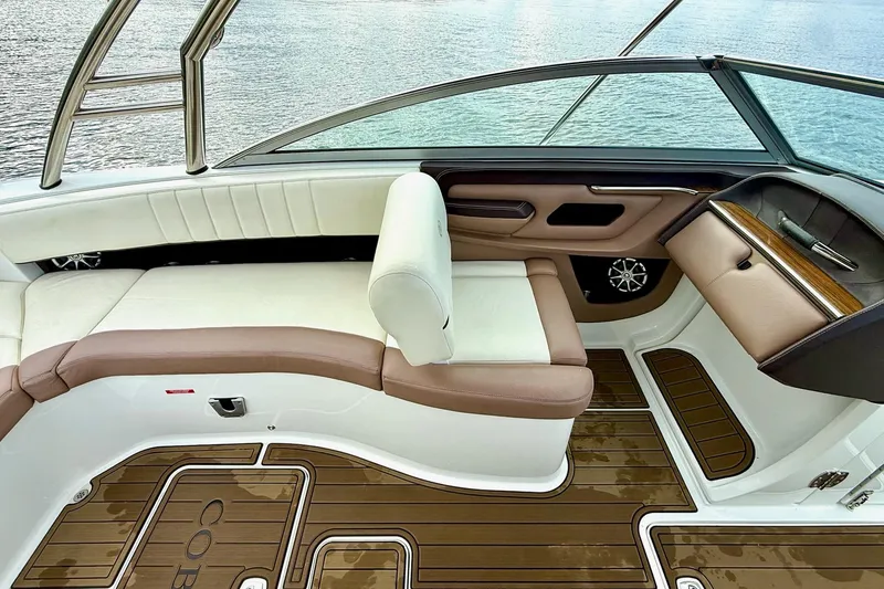 Slide: The Image of Interior of a 2011 Cobalt 276 boat with white and brown seating, overlooking water. - 30