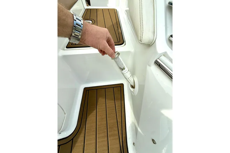 Slide: The Image of Hand holding a boat handle on a 2011 Cobalt 276 deck. - 34