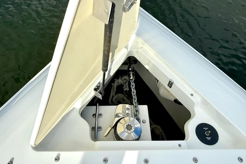 Slide: The Image of Open anchor locker on 2011 Cobalt 276 boat, showing chain and winch mechanism. - 37