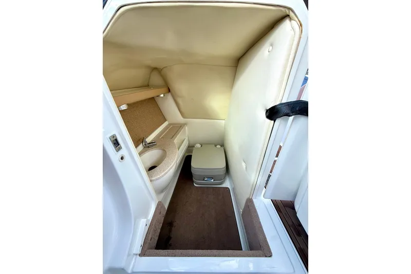 Slide: The Image of 2011 Cobalt 276 boat interior with compact bathroom and sink. - 38