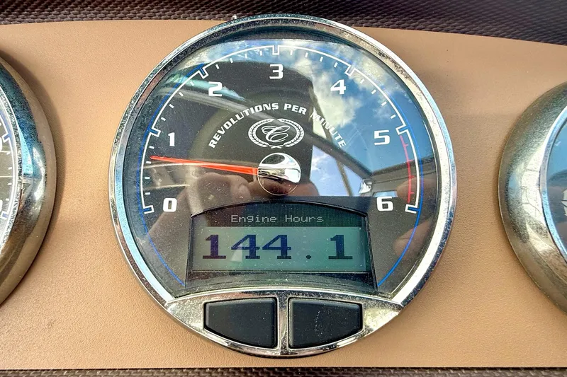 Slide: The Image of Close-up of a 2011 Cobalt 276 tachometer showing 144.1 engine hours. - 39