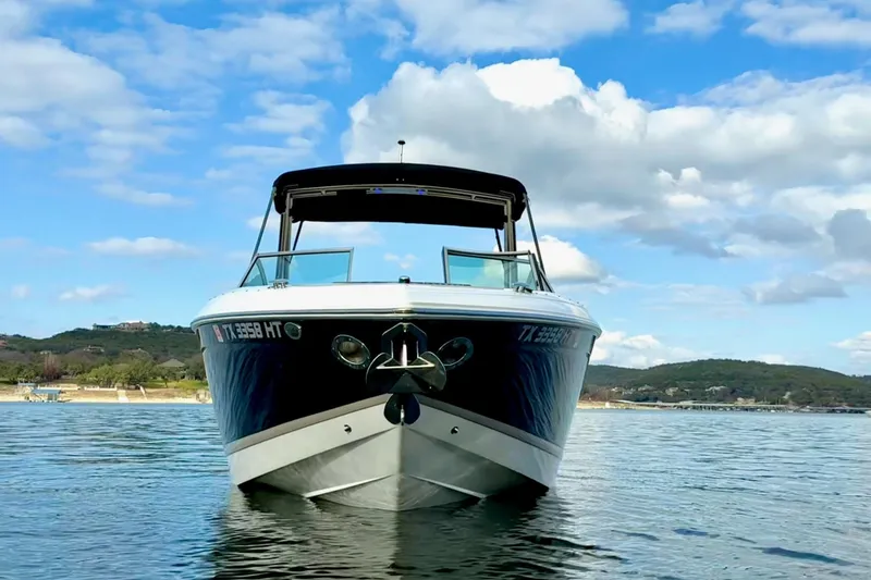 Slide: The Image of 2011 Cobalt 276 boat on calm water under a blue sky with clouds. - 4