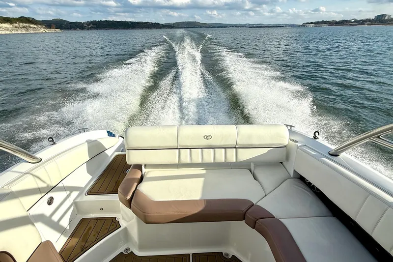 Slide: The Image of 2011 Cobalt 276 boat cruising on open water, leaving a wake behind. - 41