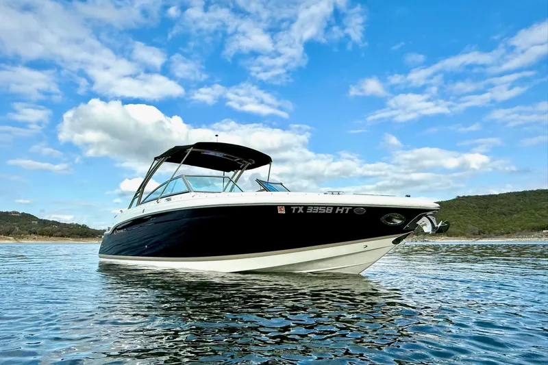 Slide: The Image of 2011 Cobalt 276 boat on calm water under a blue sky. - 5